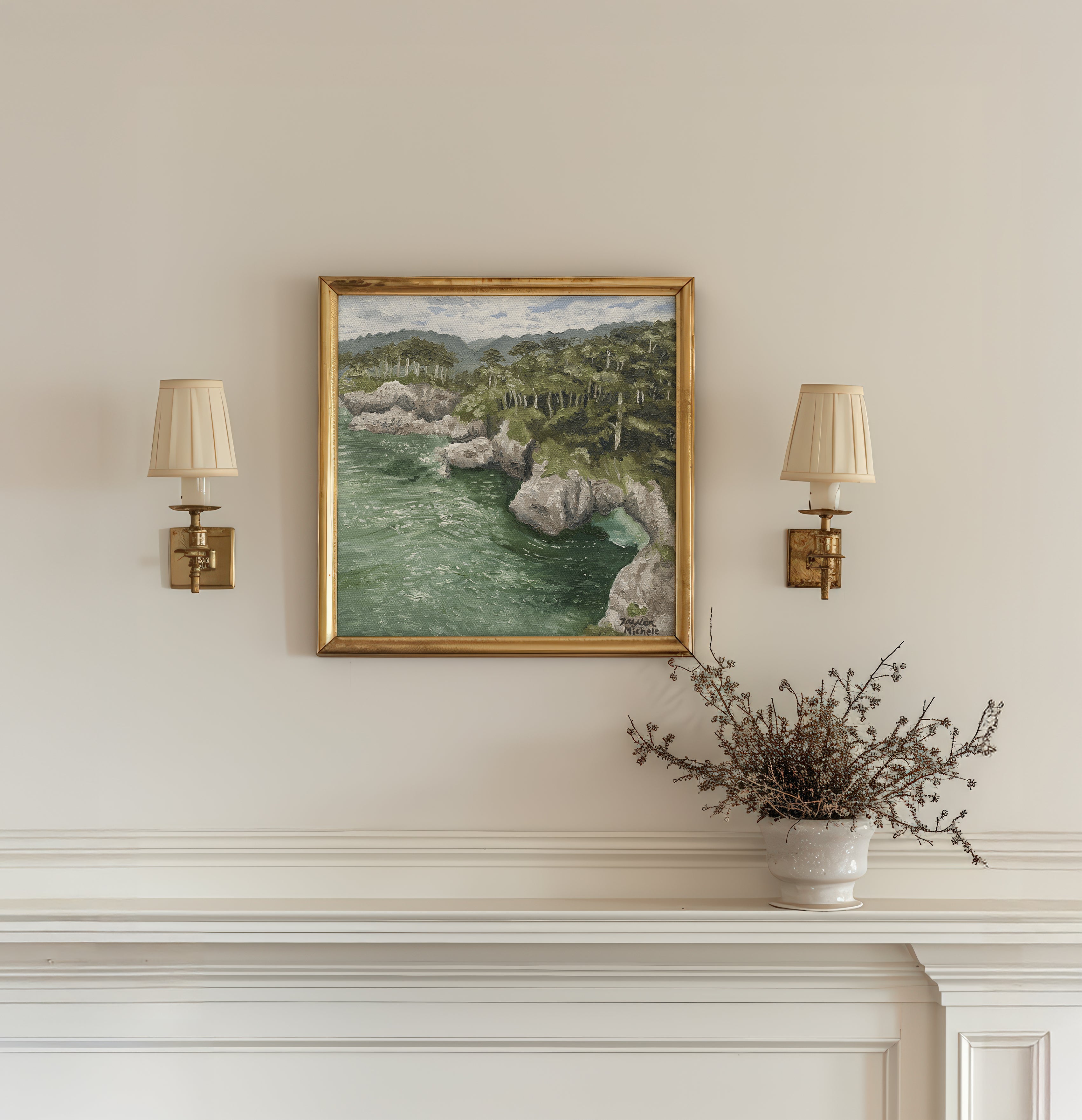Framed landscape painting above a fireplace with wall lamps and a plant.