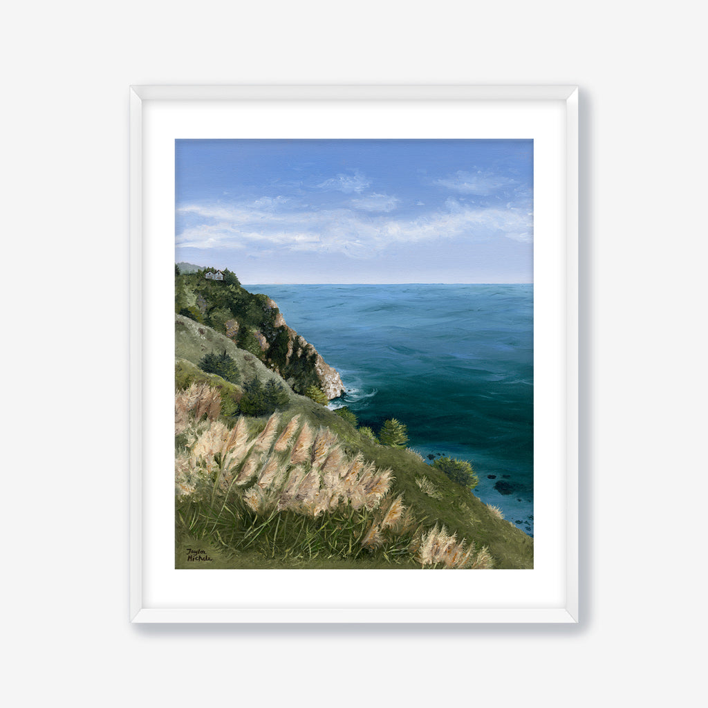 Framed artwork of a coastal landscape with grassy hill and blue ocean. White Frame