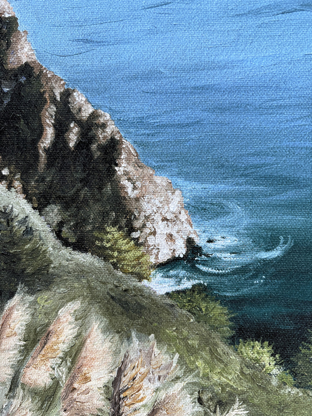 Close up of cliffside with ocean waves crashing against it