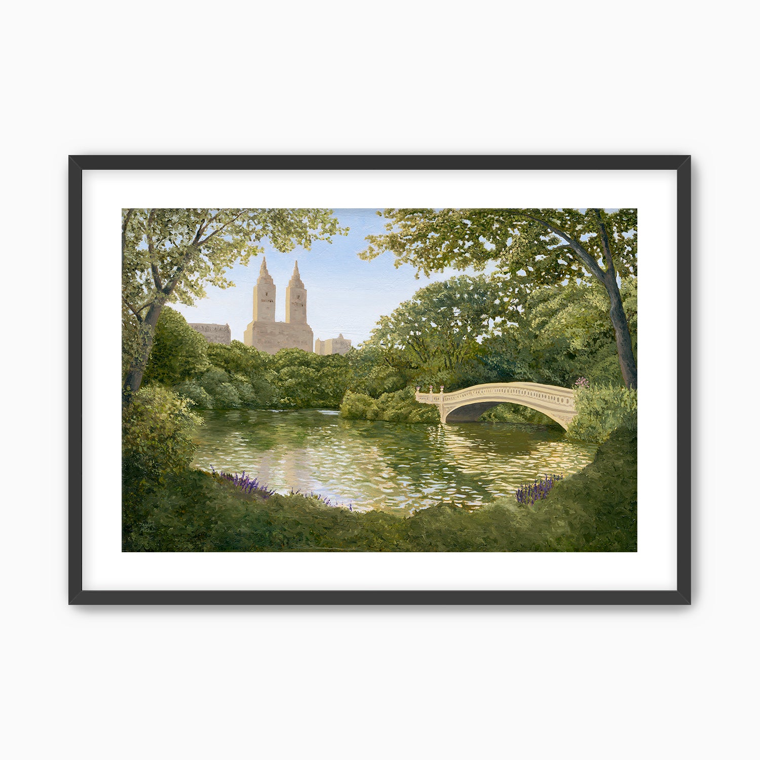 Framed artwork of a park scene with a bridge over a pond and trees. Black frame
