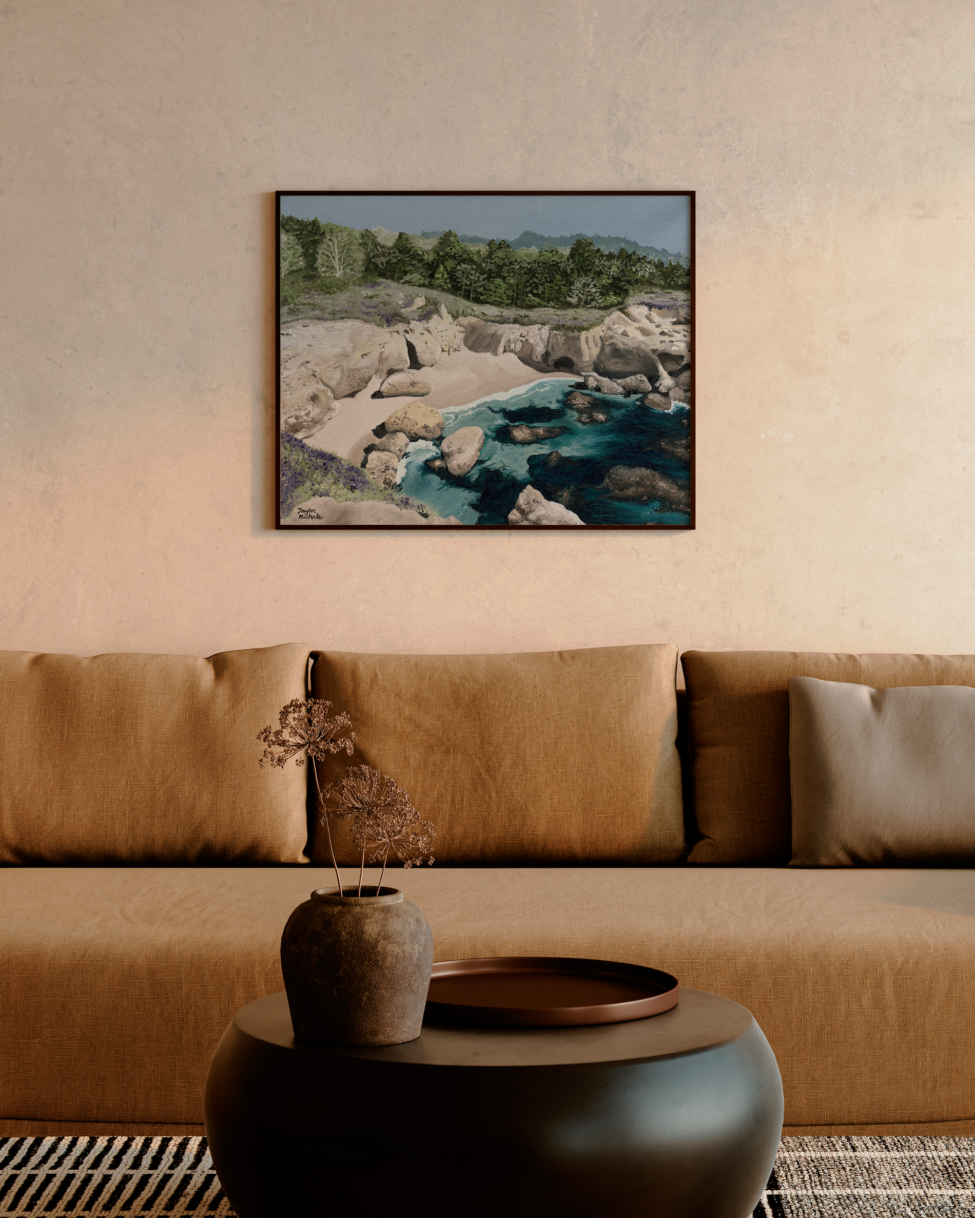 Framed landscape painting above a brown sofa in a living room.