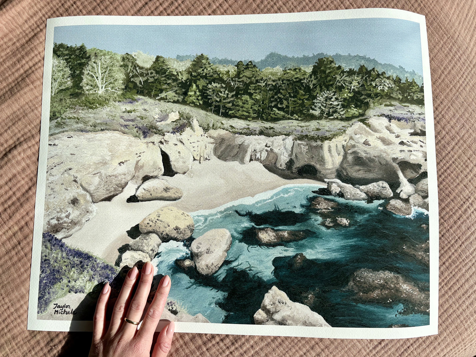 16 x 20" print of rocky coastal cove in Carmel Highlands with a hand holding the print for scale and size