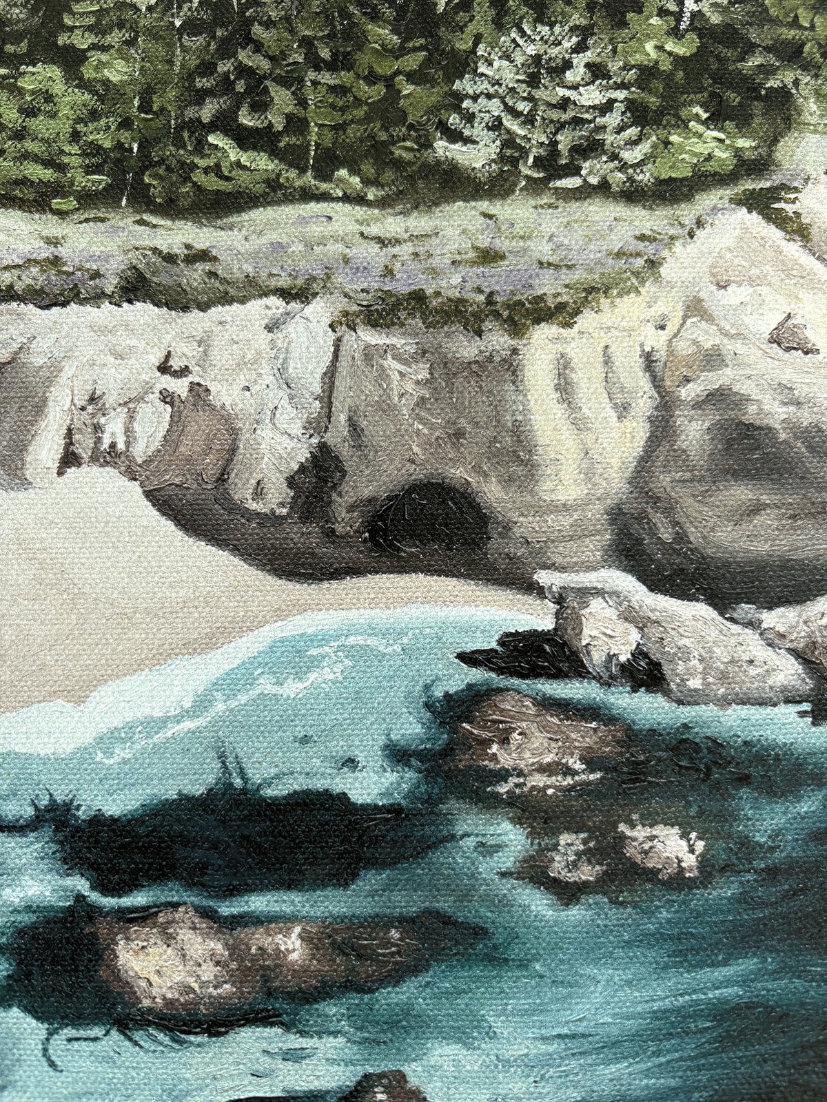 Close-up of fine art print that shows a rocky coastal beach shore with rocks and trees in the background located in Carmel
