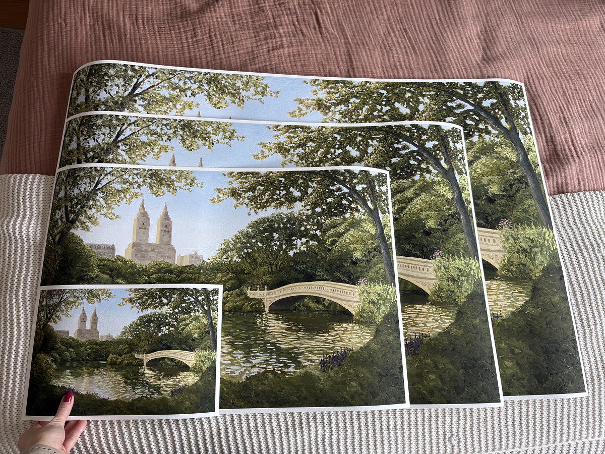 Set of prints showing a scenic landscape with a bridge and trees on a textured surface.