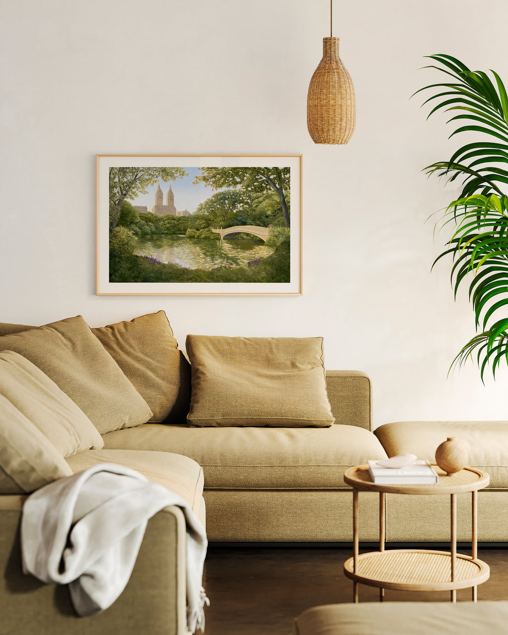 Living room with beige sectional sofa, framed artwork, and a small table.