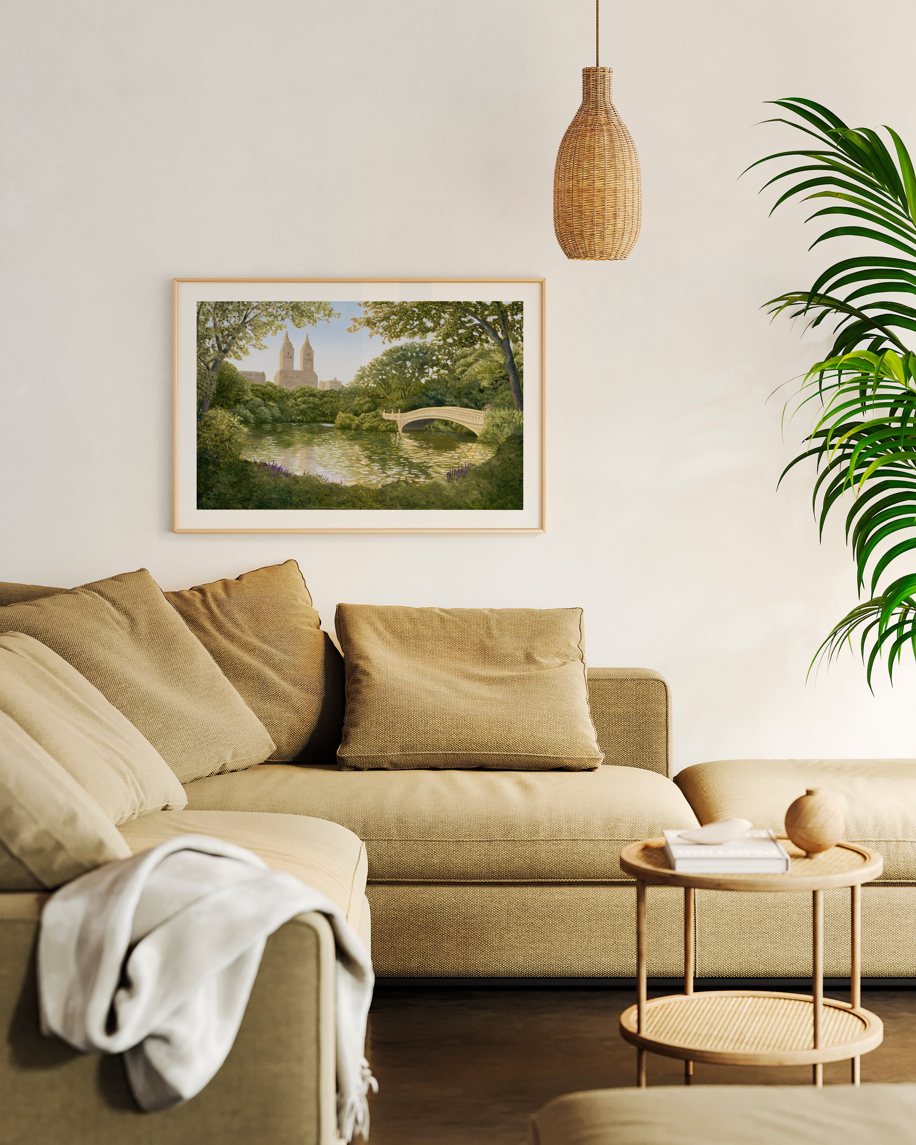 Living room with beige sectional sofa, framed artwork, and a small table.