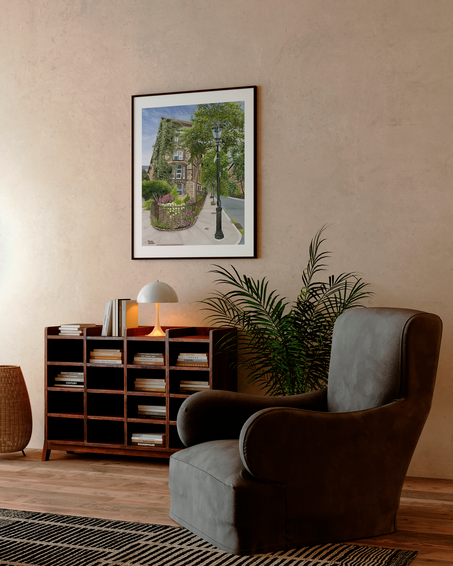 Living room with a brown armchair, wooden bookshelf, and framed picture of New York City on the wall.