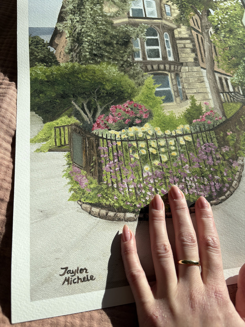 Hand holding a fine art print of an East Village Brownstone with a front garden scene.