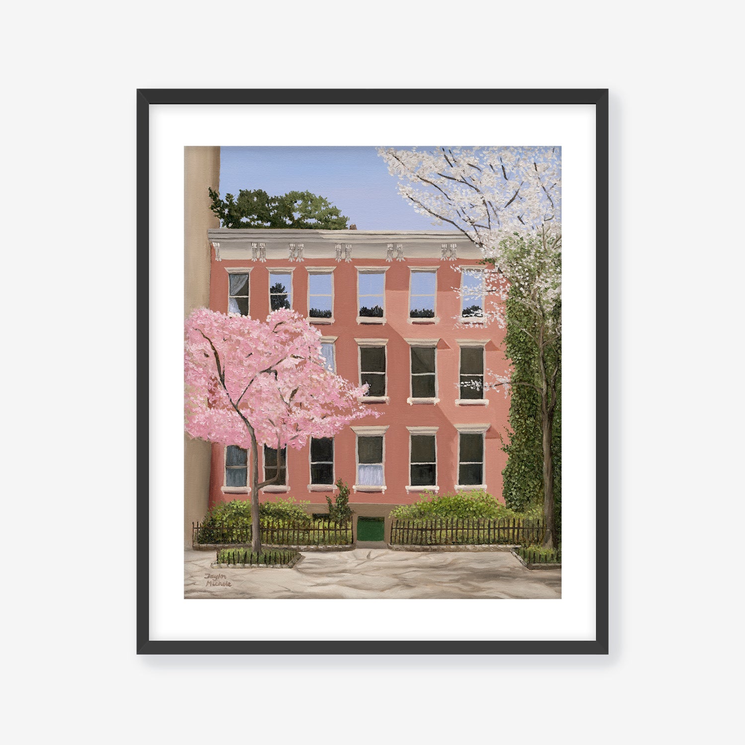 Framed artwork of a pink building with cherry blossom trees in front. Black frame