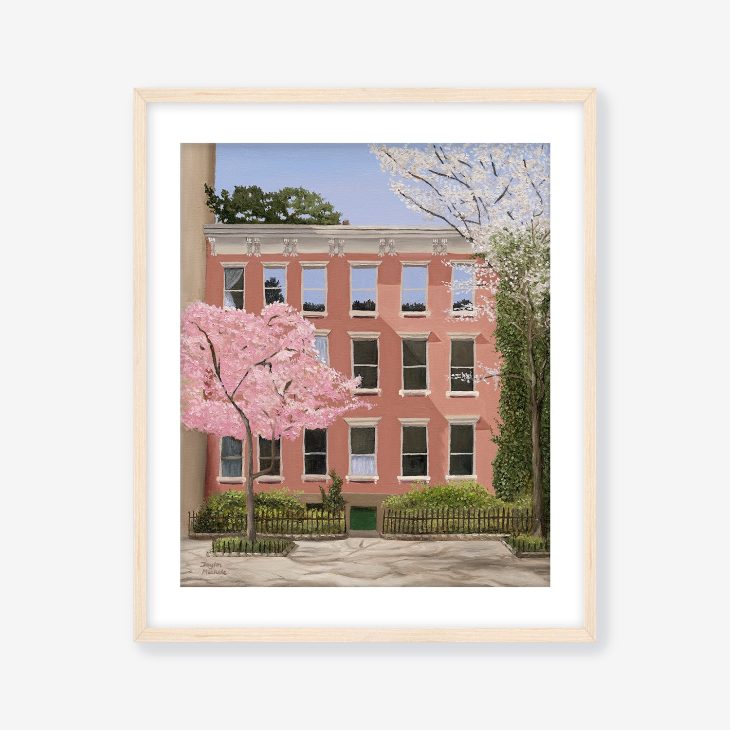 Framed artwork of a pink building with cherry blossom trees on a white background with a maple frame