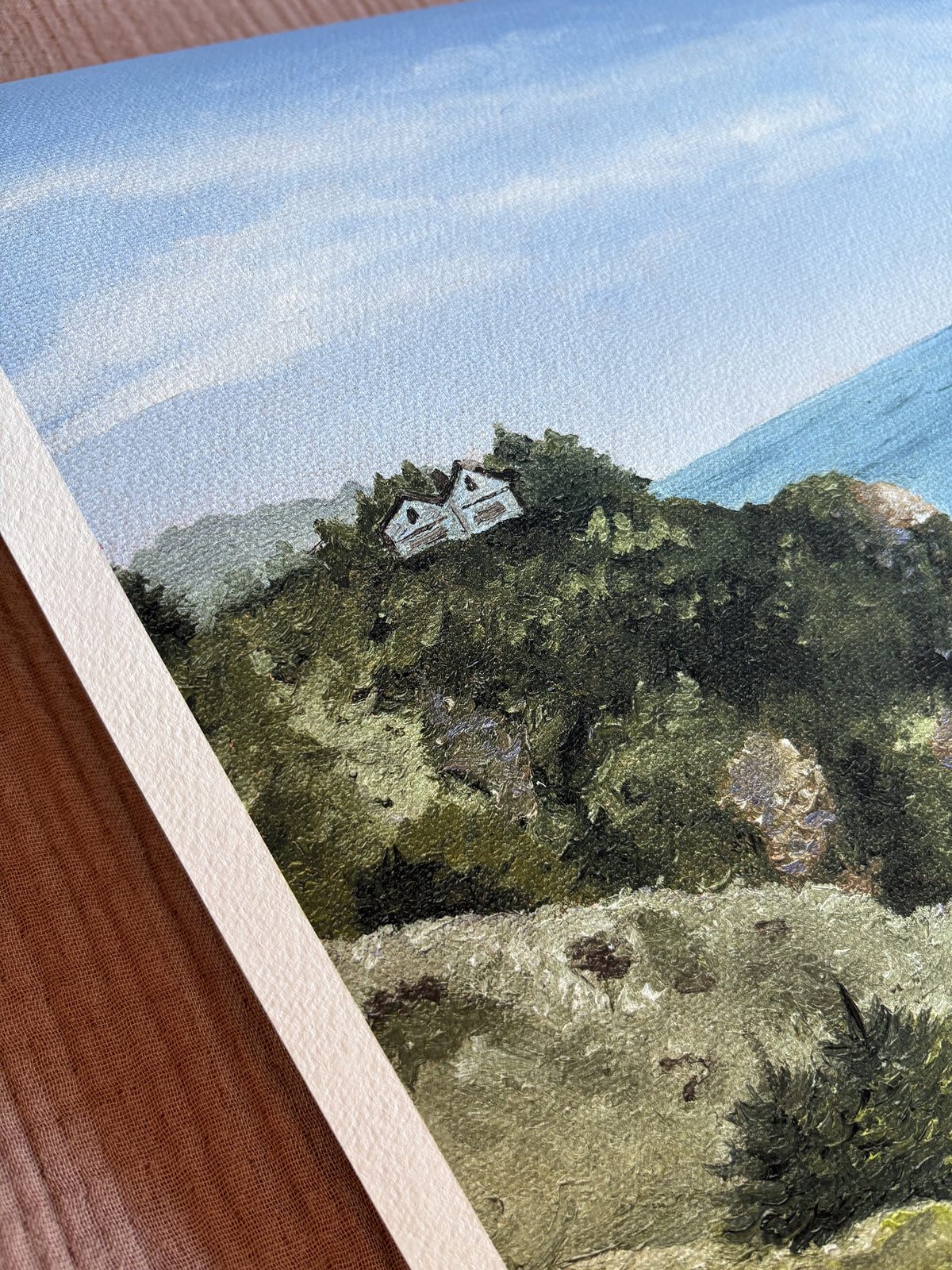 Fine art print reproduction of a house on a cliff with trees and blue sky overlooking the ocean